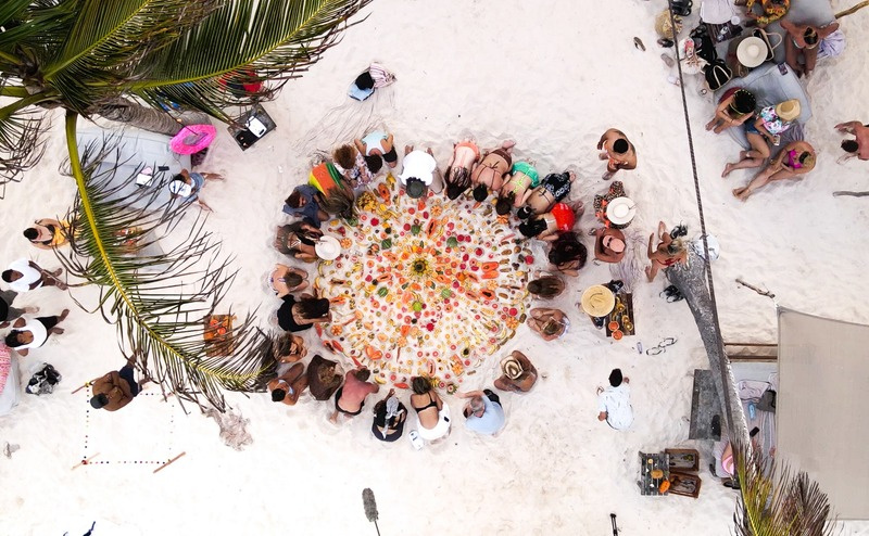 Aerial view of fruit ceremony on white sand beach