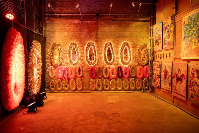 Exhibition with golden papaya sculptures in warehouse