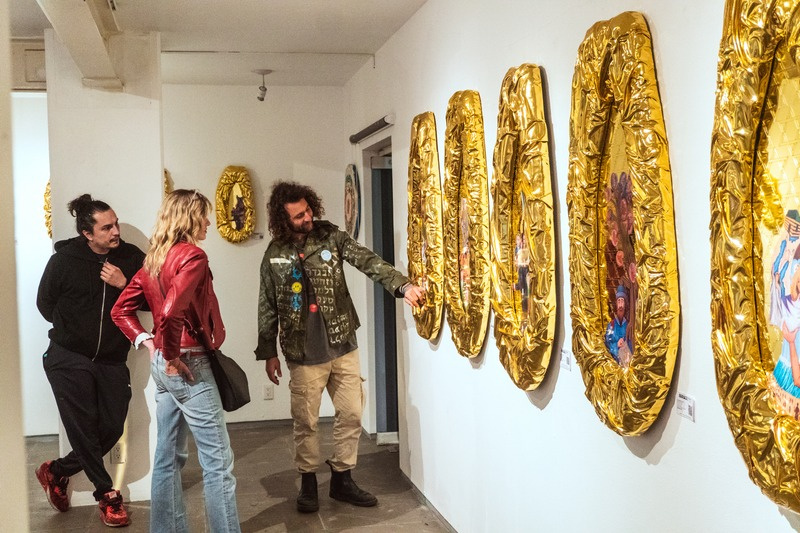 Golden papaya sculptures in white gallery